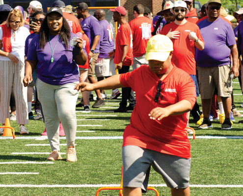 An athlete jumps over hurdles during the CSS Consumer Olympics.