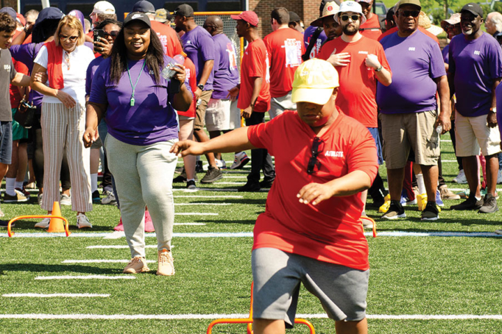 An athlete jumps over hurdles during the CSS Consumer Olympics.