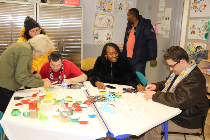 Individuals supported by CSS make December crafts.